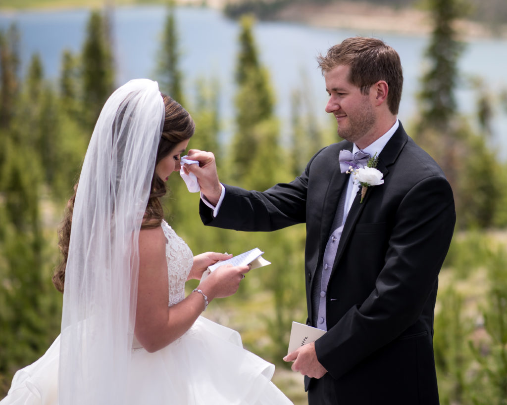 wiping tears during private vows before ceremony in breckenridge, colorado