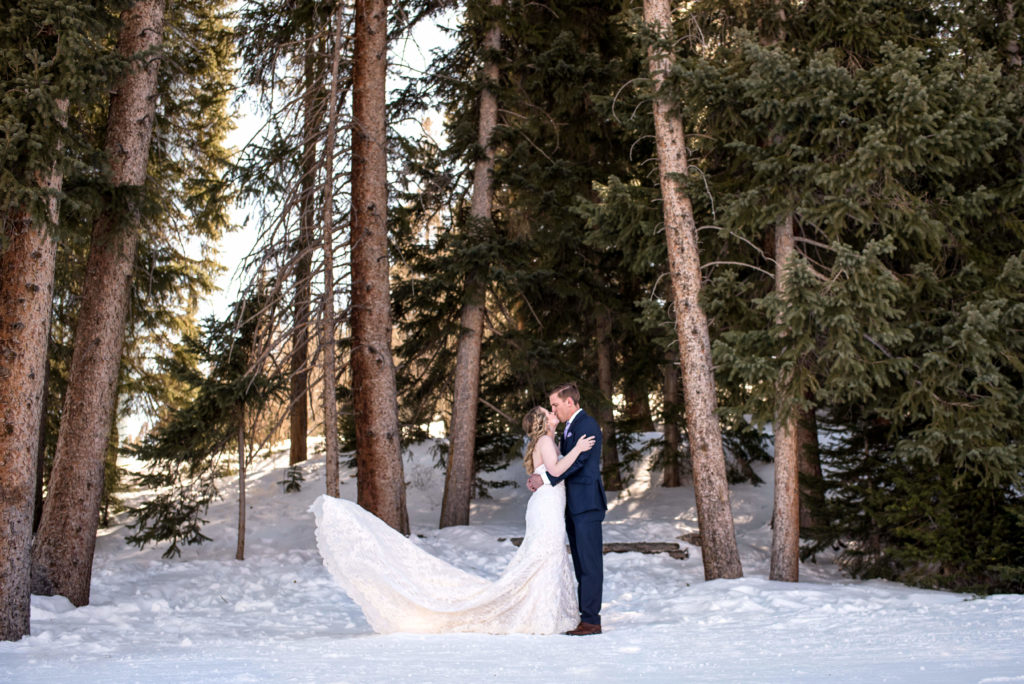 Bride and groom in the woods at Breckenridge Ski resort mountain during their winter elopement in Colorado