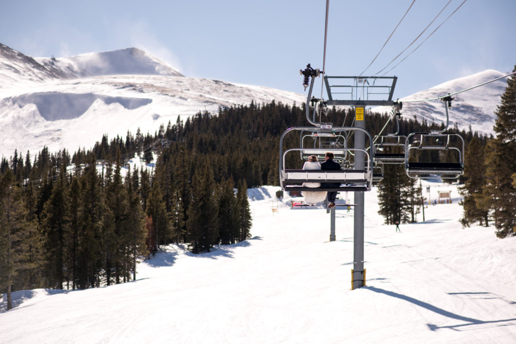 Couple on chairlift at Breckenridge Ski Resort for their Colorado winter elopement