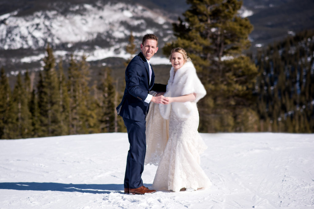 Couple dancing on the top of the mountain at Breckenridge Ski Resort during their Colorado winter elopement in Breckenridge