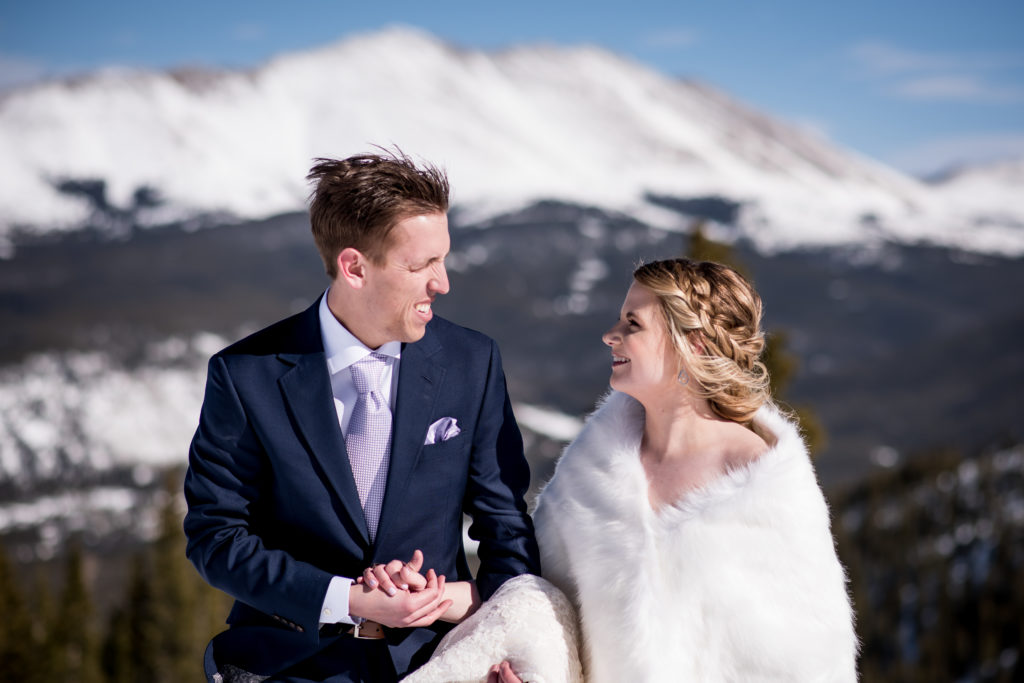 Couple walking on top of Breckenridge ski resort mountain on Colorado winter elopement day
