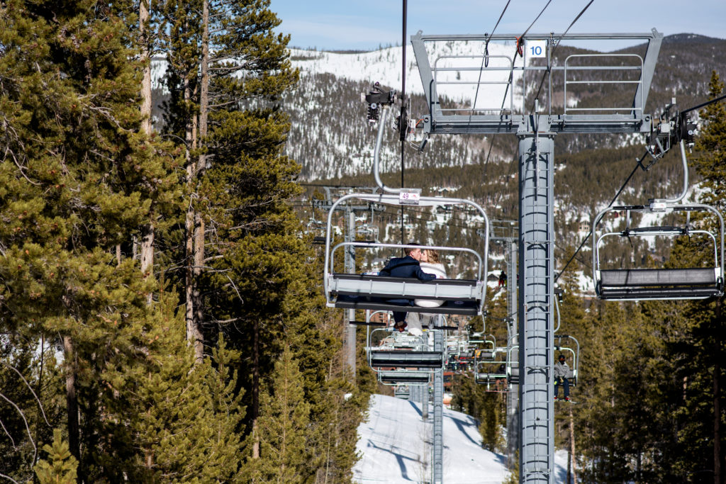 Couple on chairlift during winter ski resort elopement in Breckenridge Colorado