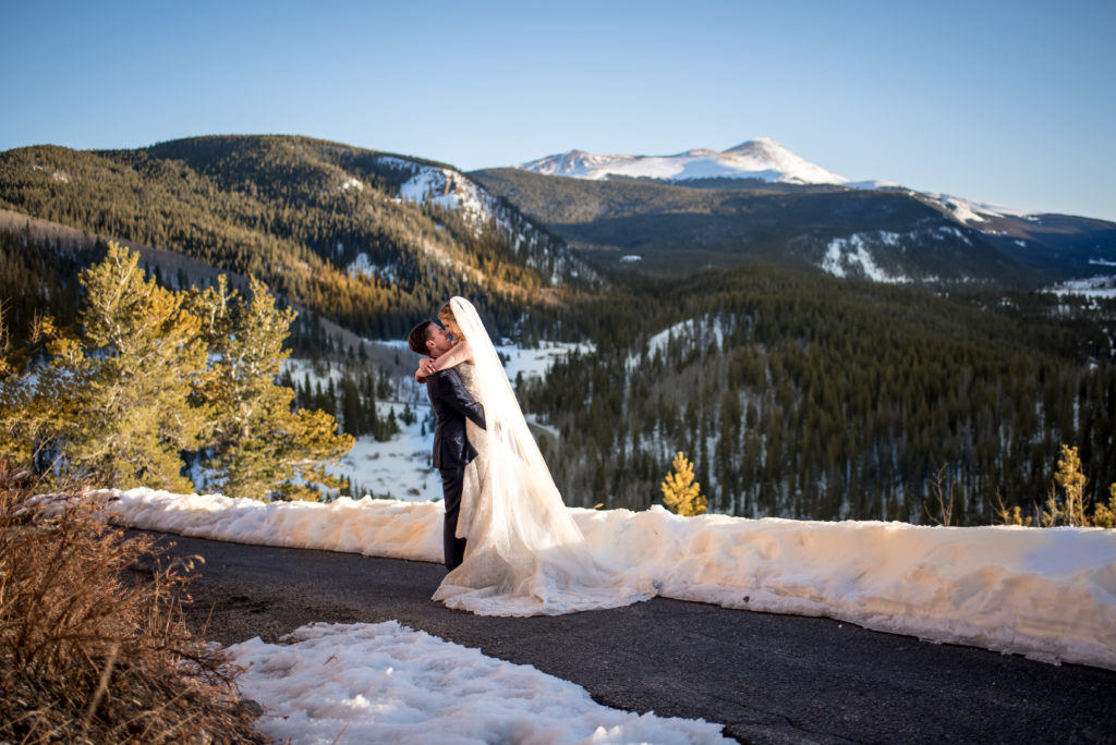 Winter wedding sunset portraits in the mountains at The Lodge at Breckenridge in Breckenridge, Colorado 
