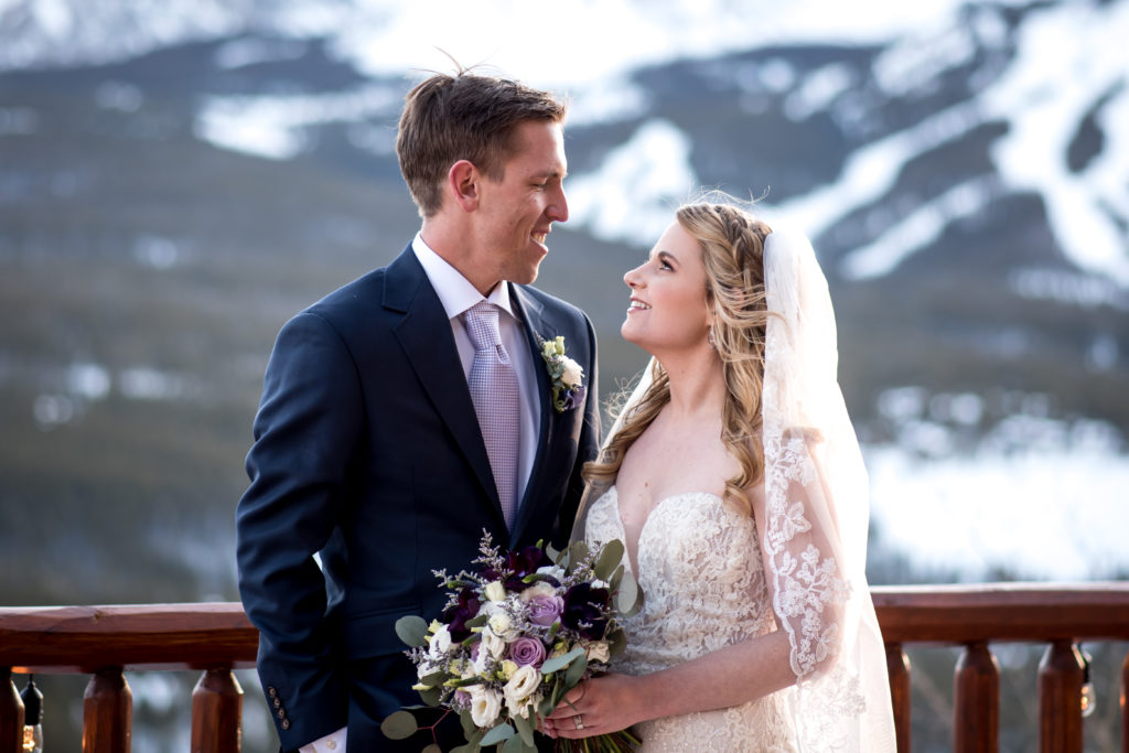 Winter wedding sunset portraits in the mountains with Breckenridge Ski Resort in the background at The Lodge at Breckenridge in Colorado 