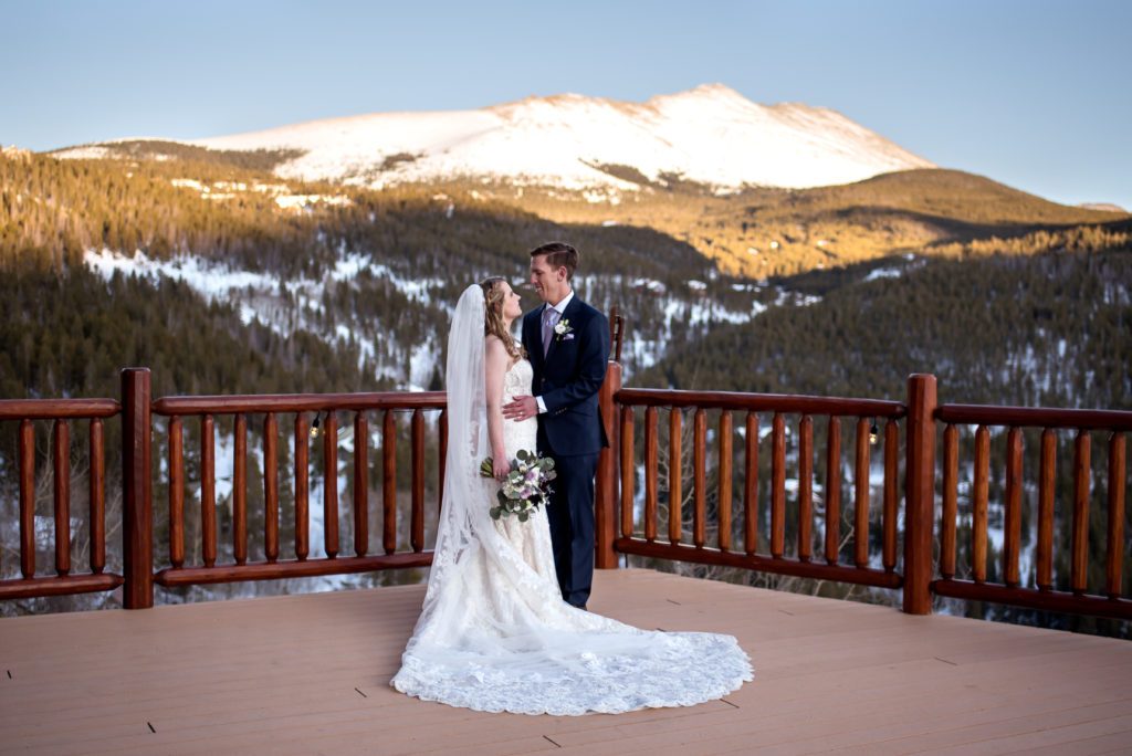 Winter wedding sunset portraits with mountain alpenglow at The Lodge at Breckenridge in Breckenridge, Colorado 