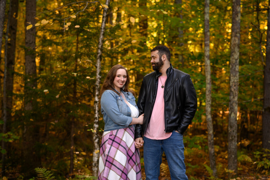 Couple arm in arm along a Sunapee fall foliage trail