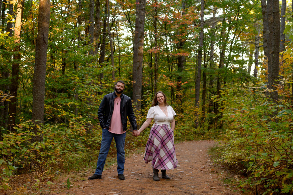 Couple hand in hand facing the camera during their NH engagement session