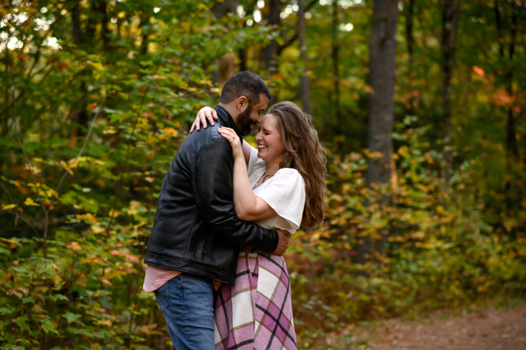 Couple laughing while forehead to forehead in an embrace