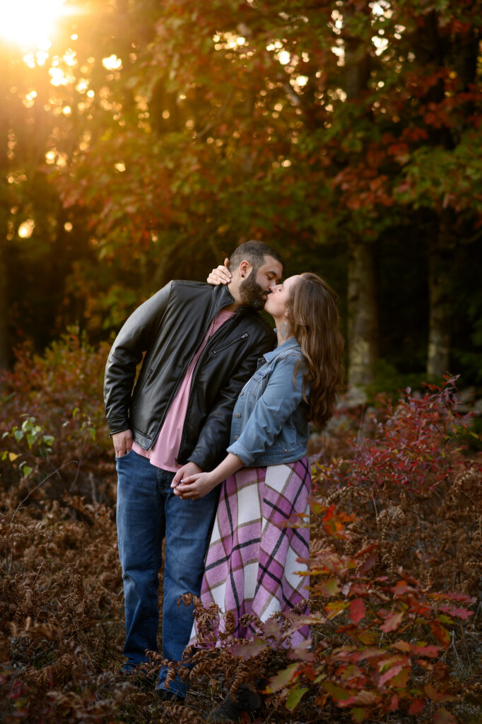 Couple kissing in red foliage