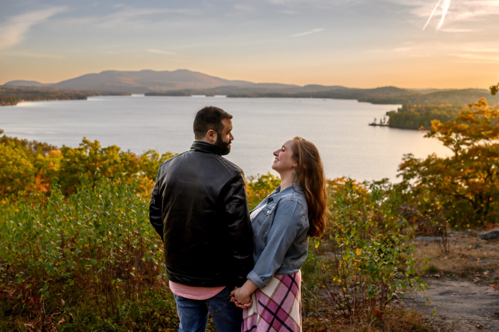 Couple in front of lake overlook in nh during golden hour
