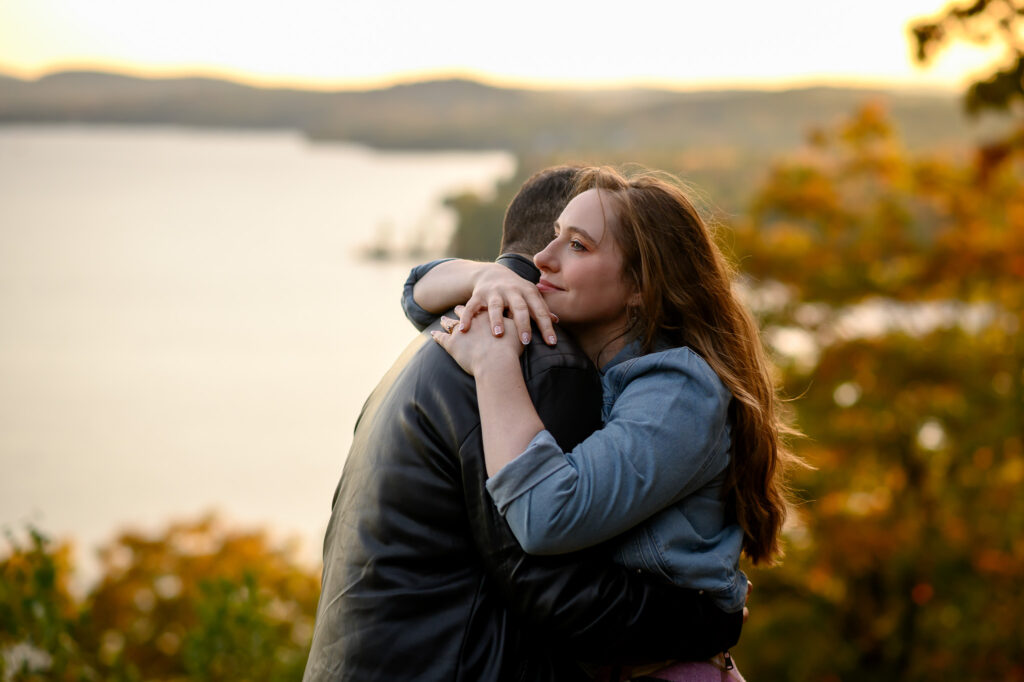 couple in warm embrace with golden light surrounding them durring a fall evening