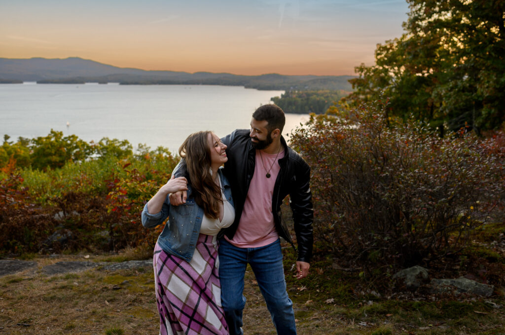 Couple walking arm and arm up a trail overlook in new england