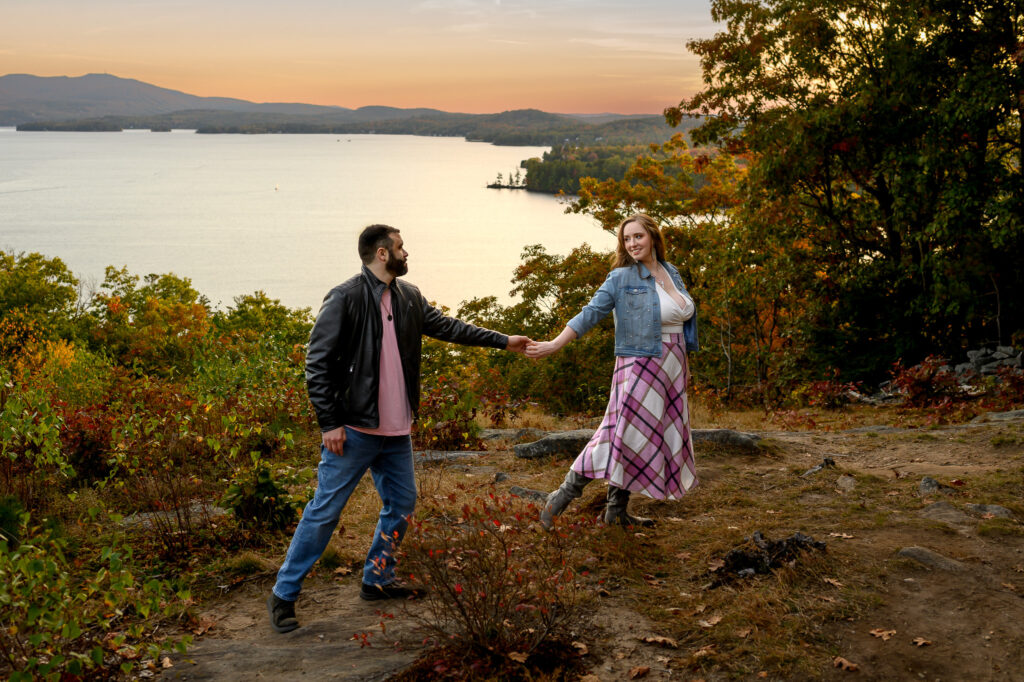 couple walking hand in hand across an open overlook path