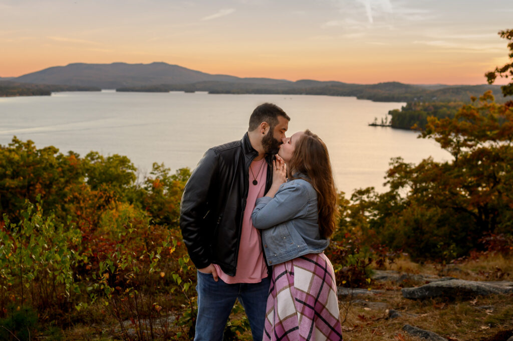 couple kissing during sunset at a lake