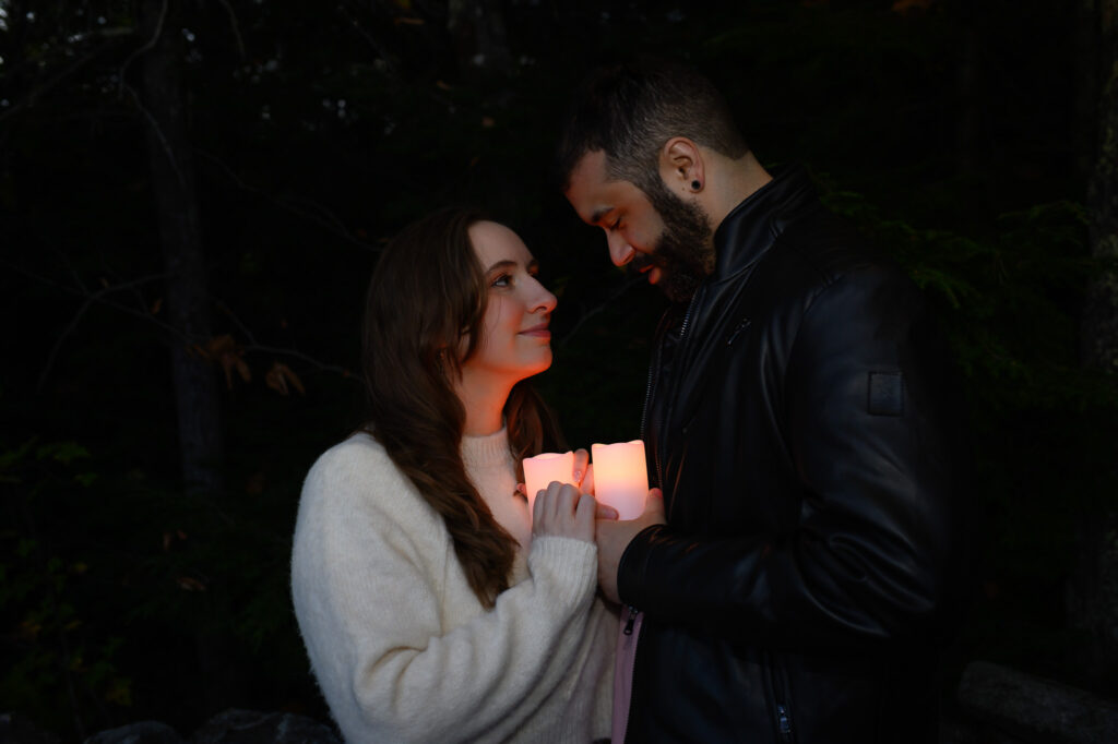 Couple in the dark with candles in a romantic moment